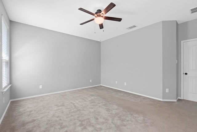 1180 Verna Brooks Way, Kyle, TX 78640 - empty room with a ceiling fan, healthy amount of natural light, carpet flooring, and baseboards