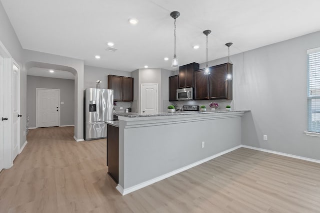 1180 Verna Brooks Way, Kyle, TX 78640 - kitchen featuring appliances with stainless steel finishes, light wood-type flooring, dark brown cabinetry, baseboards, and recessed lighting