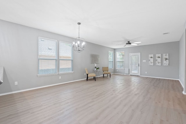 1180 Verna Brooks Way, Kyle, TX 78640 - unfurnished room featuring light wood finished floors, ceiling fan, baseboards, and a chandelier