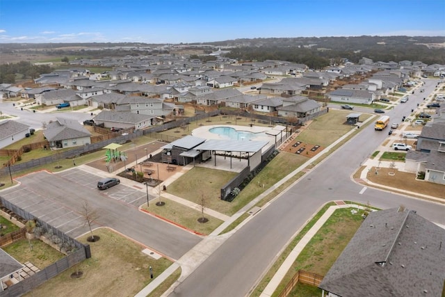 aerial overview of property's location featuring nearby suburban area and a pool area