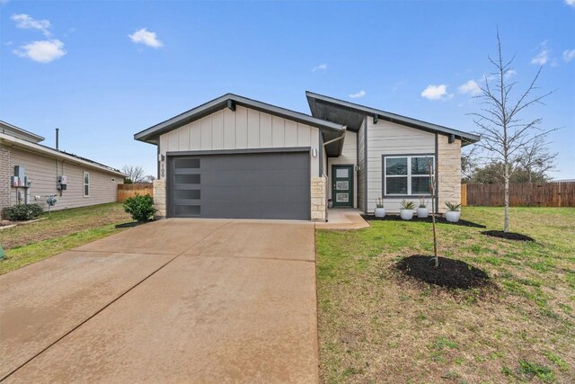 100 Deserti Rd, Leander, TX 78641 - view of front of house featuring a garage, driveway, stone siding, and board and batten siding