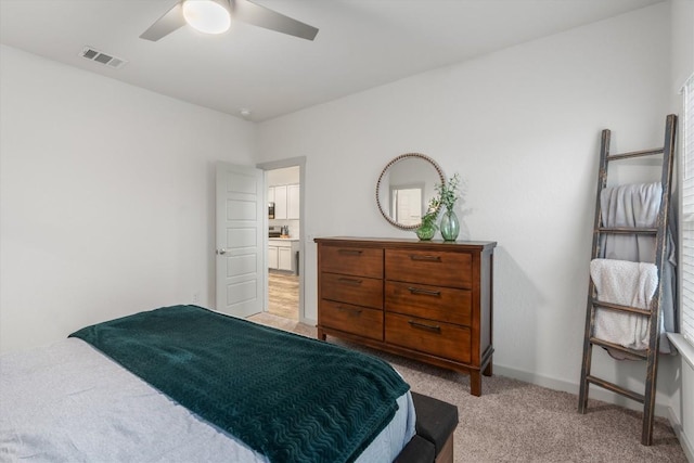 bedroom featuring light colored carpet, ceiling fan, and baseboards