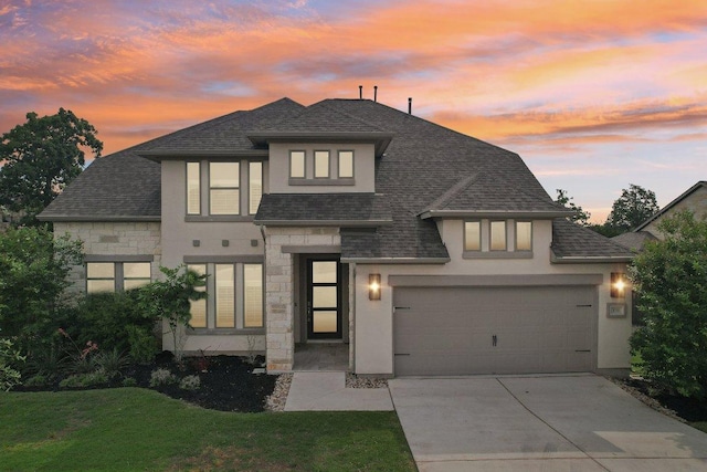 view of front of home with stone siding, driveway, stucco siding, and a front lawn