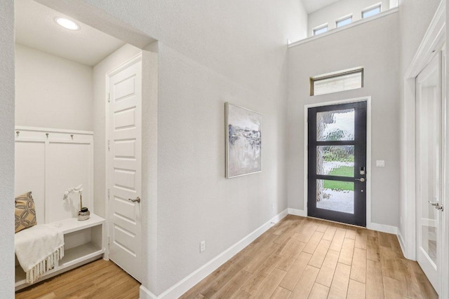 entryway with light wood-style floors and baseboards