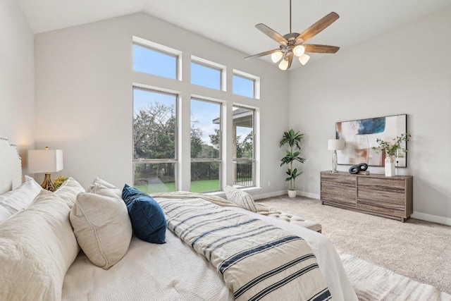 bedroom featuring carpet floors, high vaulted ceiling, baseboards, and a ceiling fan
