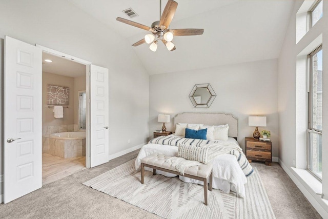 carpeted bedroom with lofted ceiling, baseboards, ensuite bath, and a ceiling fan