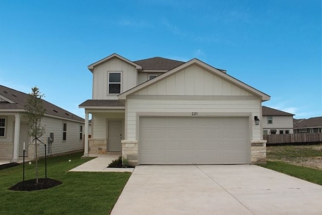 221 Escape Way, Jarrell, TX 76537 - view of front facade with driveway, board and batten siding, stone siding, and a front lawn