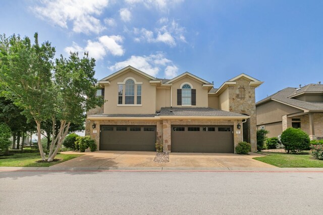 9617 Solana Vista Loop Unit A, Austin, TX 78750 - traditional-style house featuring stucco siding, an attached garage, driveway, and stone siding