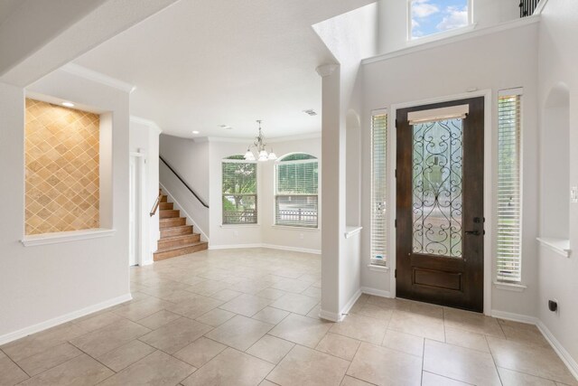 9617 Solana Vista Loop Unit A, Austin, TX 78750 - entryway with a chandelier, stairway, baseboards, ornamental molding, and light tile patterned floors
