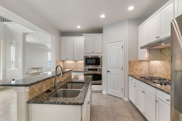 9617 Solana Vista Loop Unit A, Austin, TX 78750 - kitchen featuring stainless steel appliances, a sink, under cabinet range hood, light tile patterned floors, and recessed lighting