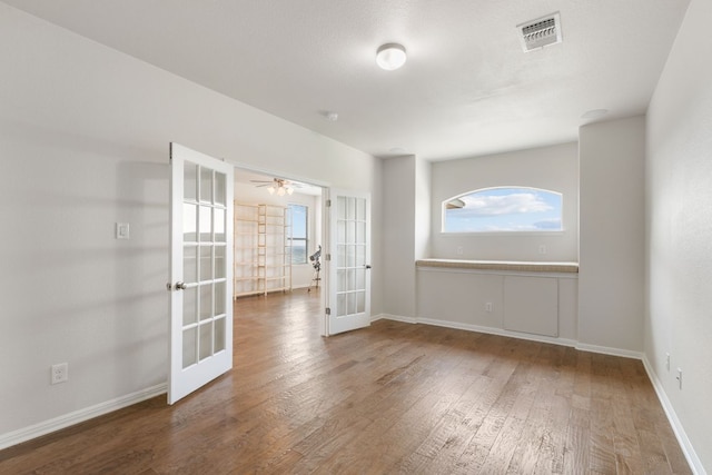 9617 Solana Vista Loop Unit A, Austin, TX 78750 - unfurnished room featuring french doors, wood finished floors, baseboards, a smoke detector, and ceiling fan