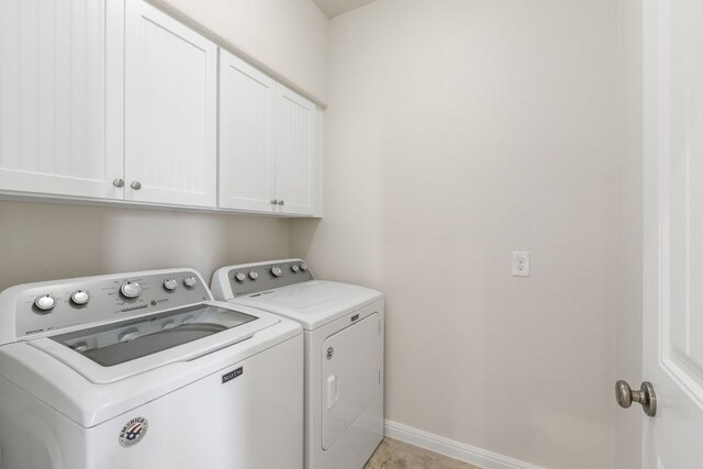 9617 Solana Vista Loop Unit A, Austin, TX 78750 - laundry area featuring washer and clothes dryer, cabinet space, and baseboards