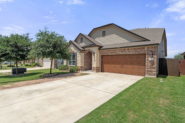 13804 Lyndon B Johnson St, Manor, TX 78653 - french country inspired facade featuring concrete driveway, a garage, brick siding, roof with shingles, and stone siding