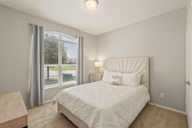 carpeted bedroom with multiple windows and baseboards