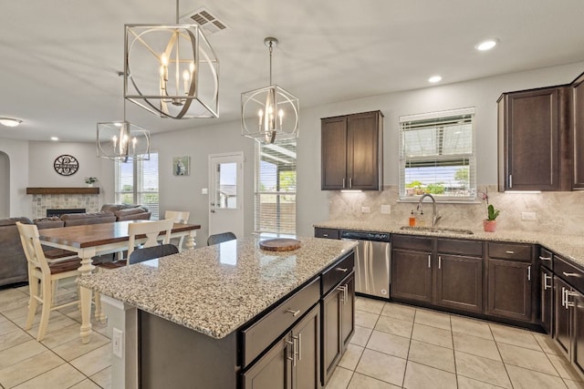 13804 Lyndon B Johnson St, Manor, TX 78653 - kitchen featuring dishwasher, light tile patterned floors, healthy amount of natural light, dark brown cabinetry, and recessed lighting