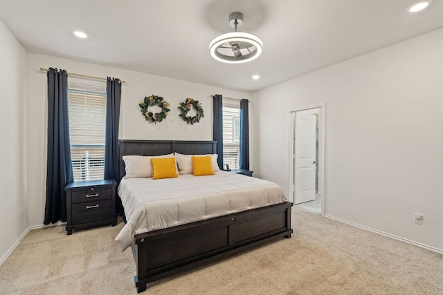 bedroom with light colored carpet, recessed lighting, and baseboards