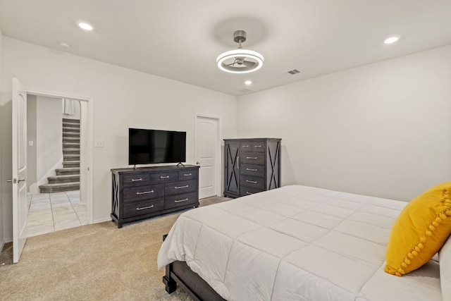 bedroom with light colored carpet, recessed lighting, and baseboards