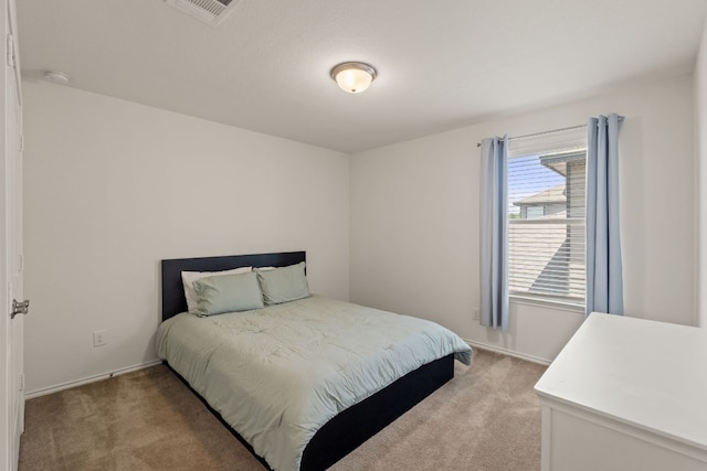bedroom with light carpet and baseboards
