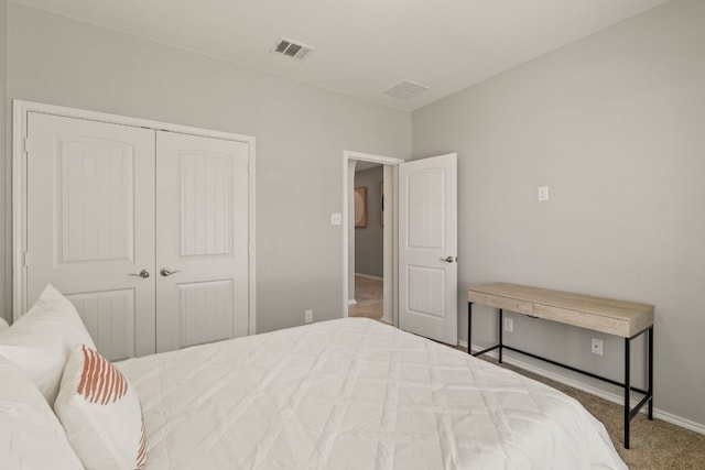 carpeted bedroom with a closet and baseboards