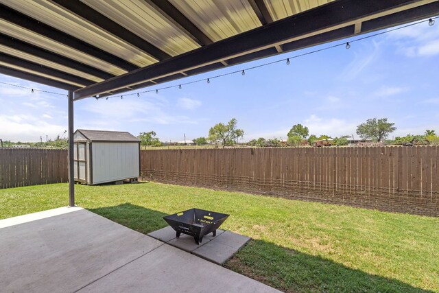 view of yard featuring a patio area, a shed, and an outdoor structure