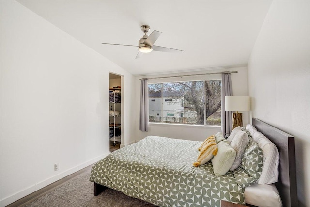 1304 Mariposa Dr Unit 214, Austin, TX 78704 - bedroom featuring wood finished floors, vaulted ceiling, a walk in closet, ceiling fan, and a closet