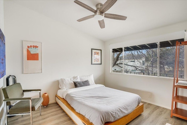 1304 Mariposa Dr Unit 215, Austin, TX 78704 - bedroom featuring wood finished floors, baseboards, lofted ceiling, and a ceiling fan