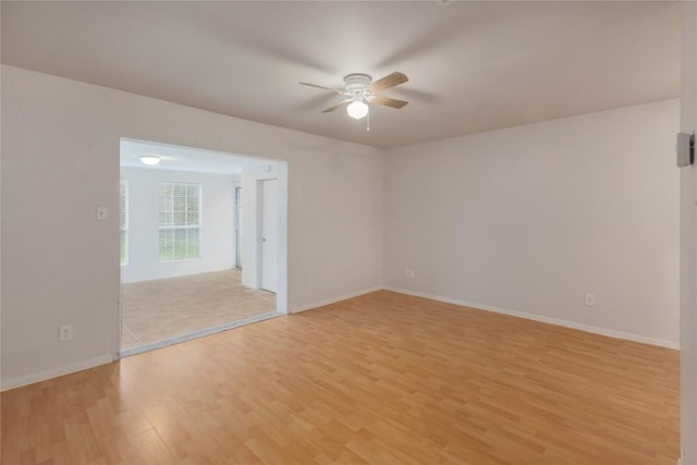 2201 Mission Hill Cir, Austin, TX 78741 - unfurnished room featuring ceiling fan, light wood-style flooring, and baseboards