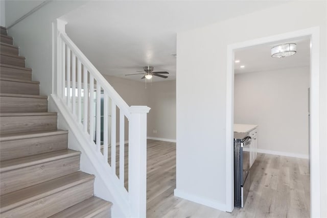 2201 Mission Hill Cir, Austin, TX 78741 - stairway with ceiling fan, wood finished floors, and baseboards