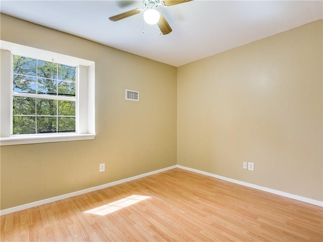 2201 Mission Hill Cir, Austin, TX 78741 - empty room featuring wood finished floors, baseboards, and a ceiling fan