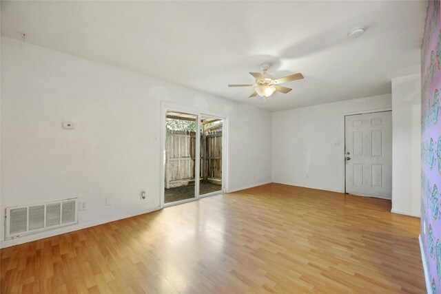 2201 Mission Hill Cir, Austin, TX 78741 - unfurnished room with a ceiling fan, light wood-type flooring, a smoke detector, and baseboards