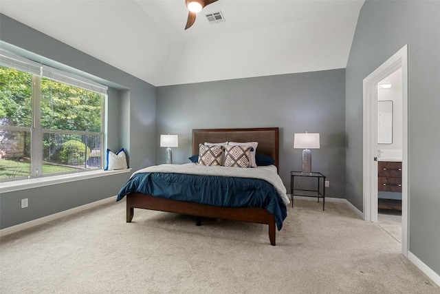carpeted bedroom with lofted ceiling, baseboards, ensuite bath, and a ceiling fan