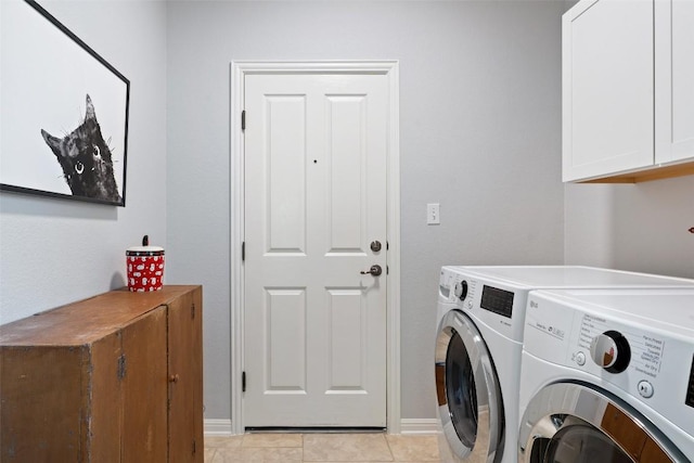 washroom with washer and dryer, cabinet space, light tile patterned floors, and baseboards