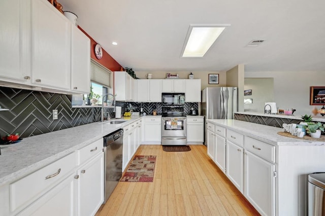 866 Bella Vista Cir, Kyle, TX 78640 - kitchen with appliances with stainless steel finishes, a sink, backsplash, and white cabinetry