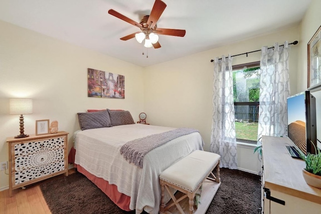 866 Bella Vista Cir, Kyle, TX 78640 - bedroom with multiple windows, wood finished floors, and ceiling fan