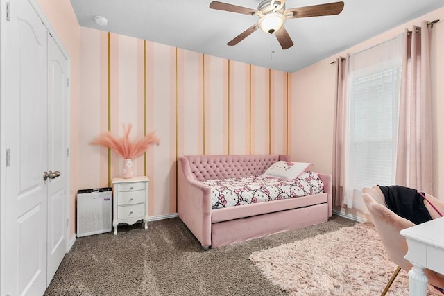 carpeted bedroom featuring wallpapered walls and ceiling fan
