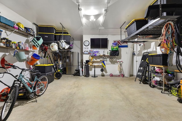 1012 Swan Flower St, Leander, TX 78641 - garage featuring stainless steel fridge