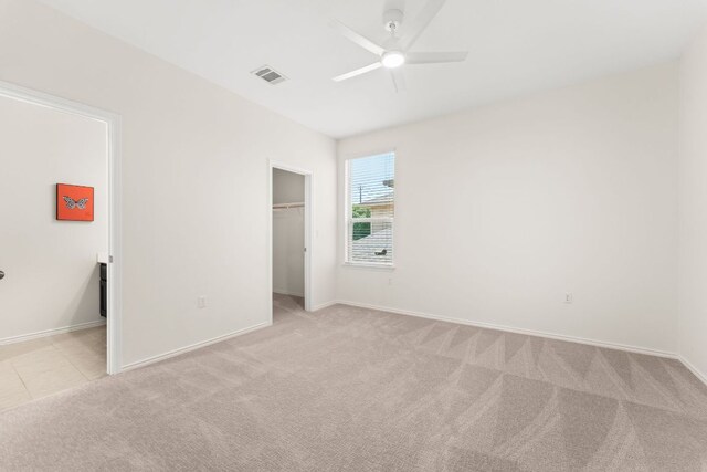 9528 Hunter Ln, Austin, TX 78748 - unfurnished bedroom featuring light colored carpet, a spacious closet, a closet, and ceiling fan