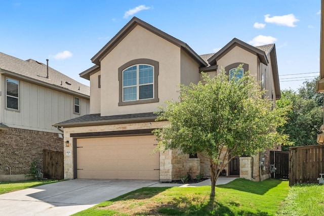 9528 Hunter Ln, Austin, TX 78748 - view of front of home featuring a garage, concrete driveway, stone siding, and stucco siding