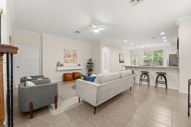 9528 Hunter Ln, Austin, TX 78748 - living room featuring arched walkways, light tile patterned floors, ornamental molding, a ceiling fan, and recessed lighting