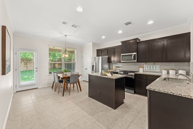 9528 Hunter Ln, Austin, TX 78748 - kitchen with stainless steel appliances, a kitchen island, dark brown cabinets, decorative light fixtures, and decorative backsplash