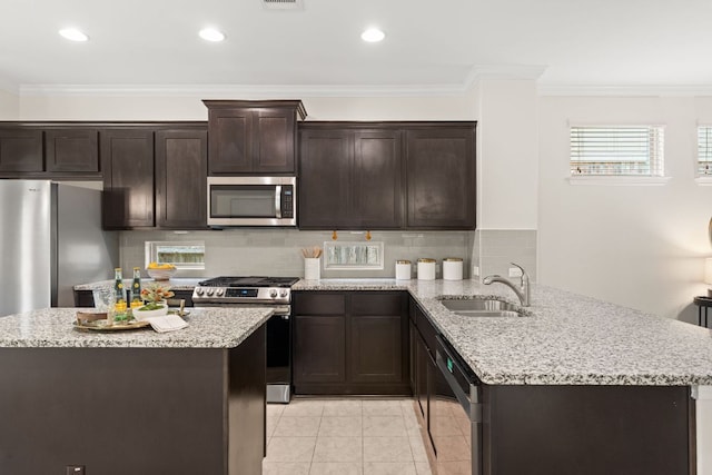 9528 Hunter Ln, Austin, TX 78748 - kitchen featuring stainless steel appliances, a sink, dark brown cabinetry, crown molding, and a peninsula
