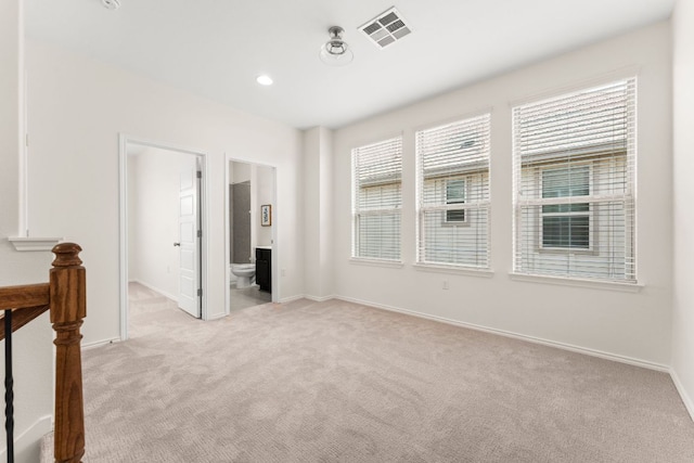 9528 Hunter Ln, Austin, TX 78748 - unfurnished bedroom with light colored carpet, multiple windows, and baseboards