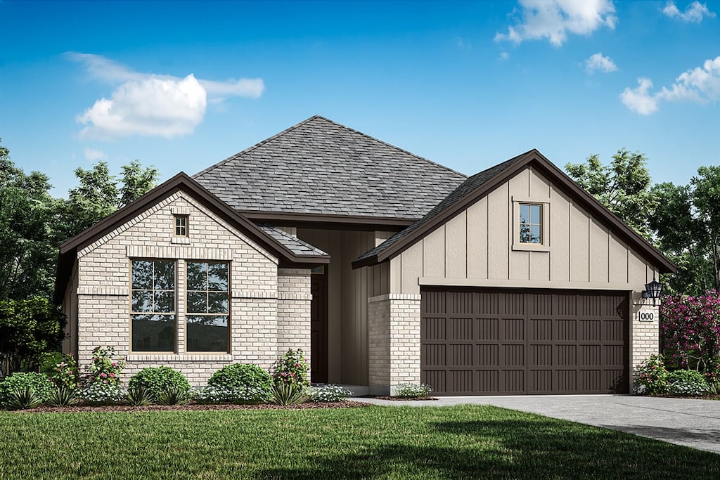 view of front of property with brick siding, a garage, a front yard, and board and batten siding
