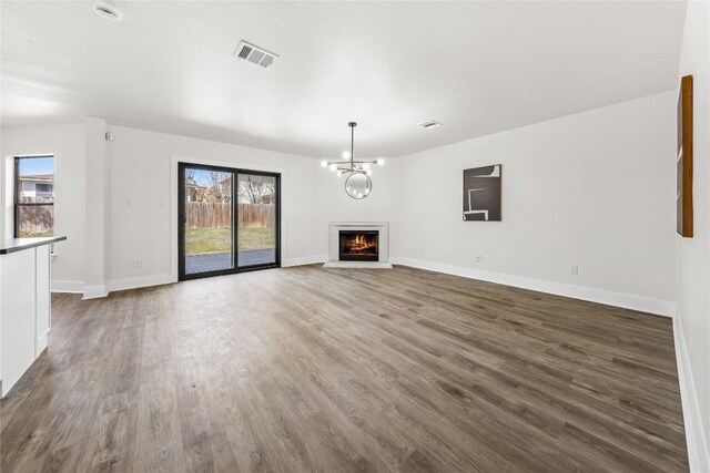 2003 Carriage Club Dr, Cedar Park, TX 78613 - unfurnished living room featuring wood finished floors and a lit fireplace