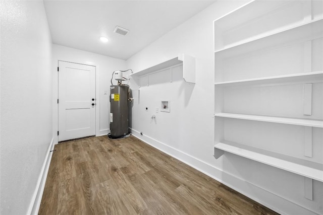 2003 Carriage Club Dr, Cedar Park, TX 78613 - washroom featuring electric water heater, washer hookup, gas dryer hookup, wood finished floors, and electric dryer hookup