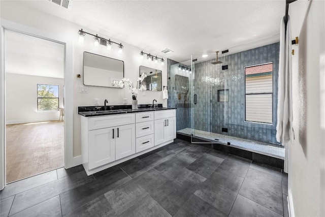 2003 Carriage Club Dr, Cedar Park, TX 78613 - bathroom featuring double vanity, a shower stall, and tile patterned floors
