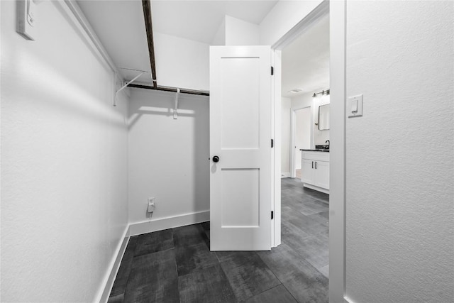 2003 Carriage Club Dr, Cedar Park, TX 78613 - laundry area with dark wood-style floors and a textured wall