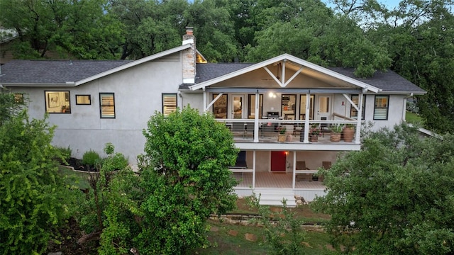 8900 Rockcrest Dr, Austin, TX 78759 - back of property with a balcony, stucco siding, a chimney, and a shingled roof