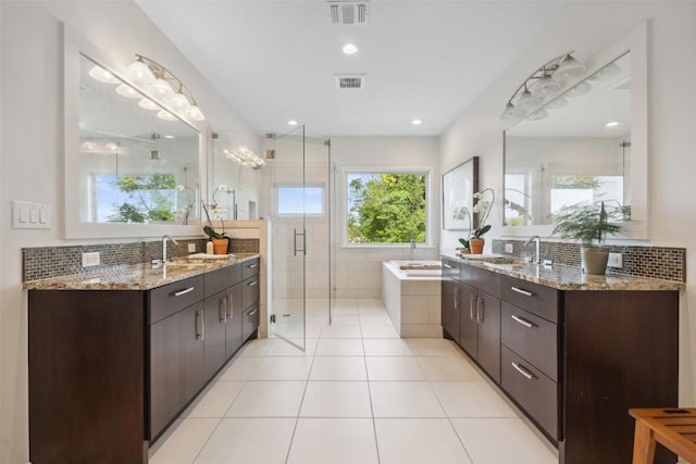 8900 Rockcrest Dr, Austin, TX 78759 - bathroom with a shower stall, two vanities, a garden tub, decorative backsplash, and recessed lighting