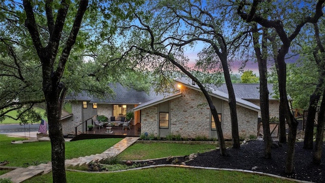 8900 Rockcrest Dr, Austin, TX 78759 - view of front of property featuring stone siding, a front yard, and a wooden deck